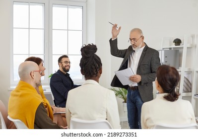 Experienced Mentor Communicating With People During Lecture Or Business Training. Coach Sharing Expertise With Team Of Multiracial Employees, Teaching How To Change Mindset, Inspiring To Achieve