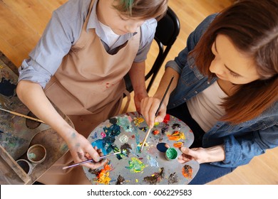 Experienced Painter Teaching Kid In The Art Studio
