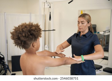 Experienced physical therapist works with ayoung patient in rehabilitation center - Powered by Shutterstock