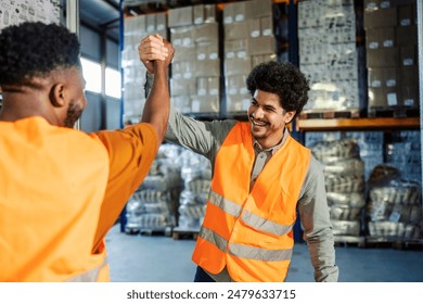 Experienced professional storage workers having bro handshake at facility. Happy team celebrating collaboration - Powered by Shutterstock