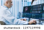 Experienced Senior Scientist Working with CT/ MRI Brain Scan Images on a Personal Computer in Laboratory. Neurologists / Neuroscientists in Research Center Work on Brain Tumor Cure.