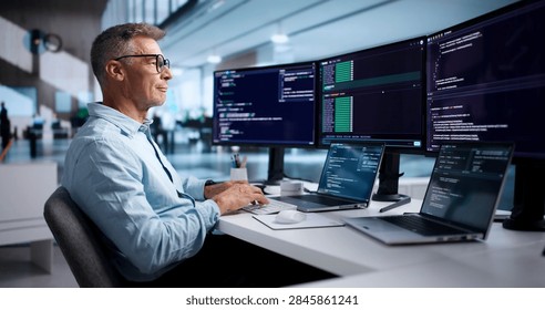 Experienced Software Developer Coding On Laptop Using Secure Cloud IDE.