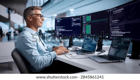 Experienced Software Developer Coding On Laptop Using Secure Cloud IDE.