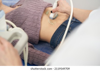 Experienced Sonographer Performing Abdominal Ultrasonography On Woman