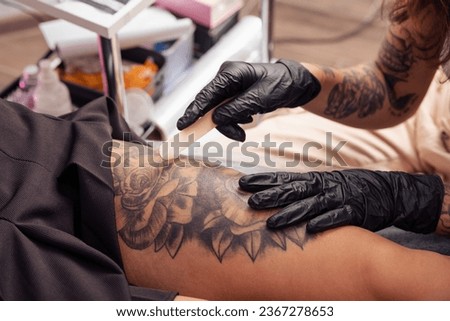 Similar – Image, Stock Photo Anonymous tattoo artist applying transfer paper on client’s back