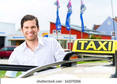 Experienced Taxi Driver In Front Of His Taxi, Waiting For A Passenger