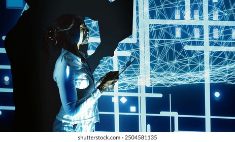 Experienced technician programming in AI server farm housing advanced equipment used for machine learning training. Skilled admin running code on tablet to upgrade artificial intelligence systems