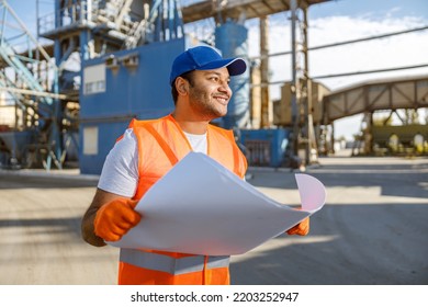 Experienced Worker Standing In Front Of Large Plant