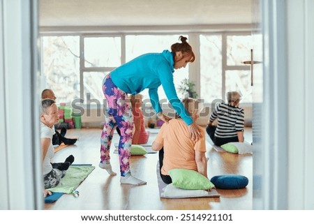 Experienced yoga instructor demonstrating safe and effective exercises for seniors to improve flexibility and balance.