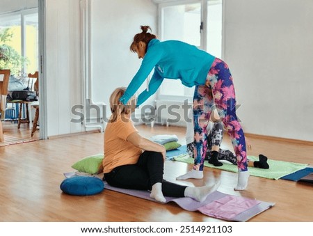 Experienced yoga instructor demonstrating safe and effective exercises for seniors to improve flexibility and balance.