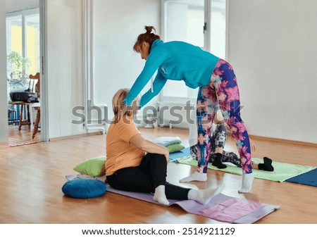 Experienced yoga instructor demonstrating safe and effective exercises for seniors to improve flexibility and balance.
