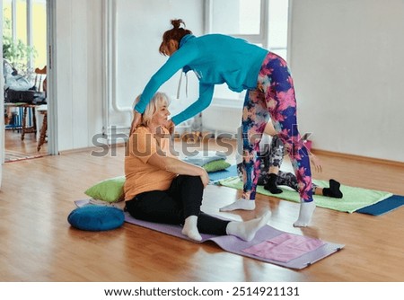 Experienced yoga instructor demonstrating safe and effective exercises for seniors to improve flexibility and balance.