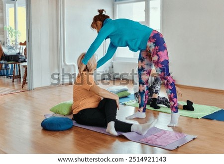 Experienced yoga instructor demonstrating safe and effective exercises for seniors to improve flexibility and balance.