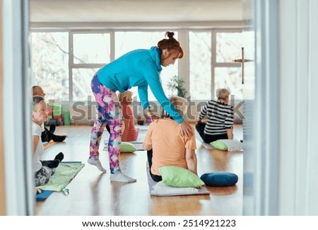 Experienced yoga instructor demonstrating safe and effective exercises for seniors to improve flexibility and balance.