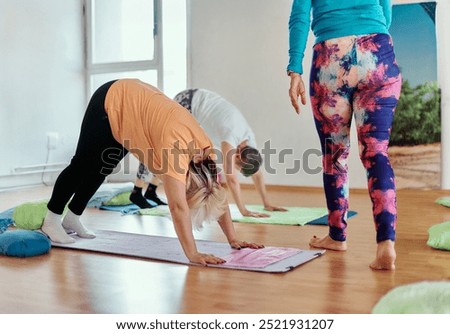Experienced yoga instructor demonstrating safe and effective exercises for seniors to improve flexibility and balance.