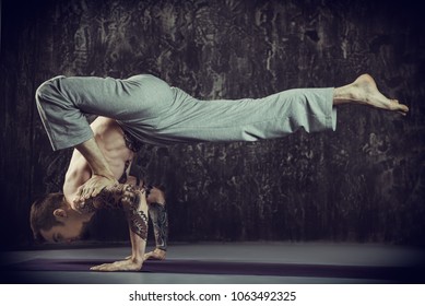 An experienced yoga instructor showing different yoga poses over dark background. Healthy lifestyle. Meditation, concentration. - Shutterstock ID 1063492325