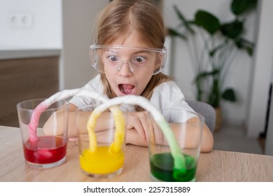 Experiment at home with food color for kids.  Early development. Chemical and scientific experiments or observations. Kid girl having classes at home enjoying art. - Powered by Shutterstock