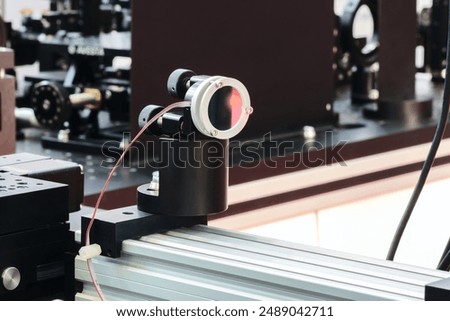Experiment with laser device in optical laboratory. Experiment in optic lab with laser device. 