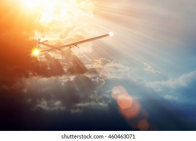 Experimental Aircraft On Sun Energy. Solar Impulse In Cloudy Sky With Sunlight