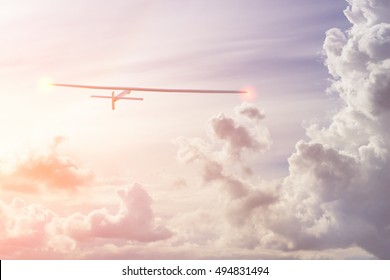 Experimental Aircraft On Sun Energy. Solar Impulse In Cloudy Sky With Sunlight