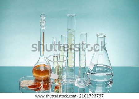 Experimental equipment such as triangular flask, cylinder, and chalet are placed.