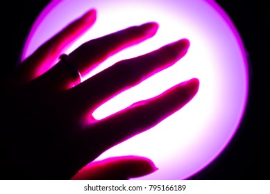 Experimental Picture Of Hand On Ultra Violet Lamp, Close Up. Vision Of Depression Or Hallucination. 