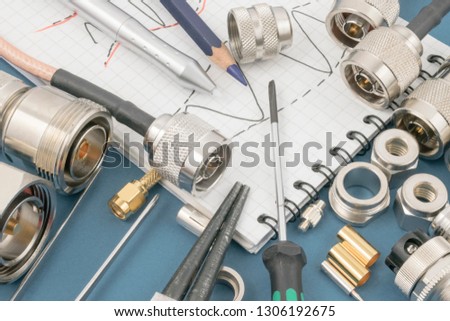 Experimentation, creative thinking and ideas in research and development process in applied science. Technology background featuring components, records and tools related to radio engineering.