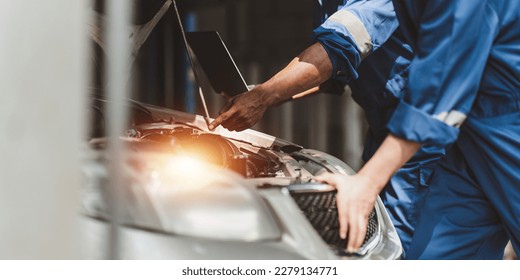 Expert auto mechanic repair and service customer service work on car at garage. automobile car concept