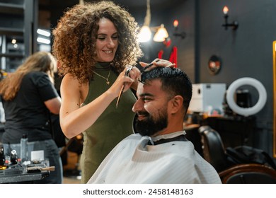 Expert barber meticulously trims and styles a man's hair using scissors, focusing on precision and style in a modern setting. - Powered by Shutterstock