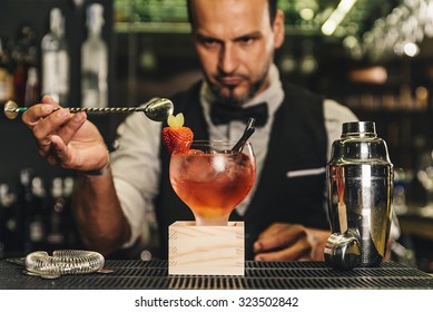 Expert Barman Is Making Cocktail At Night Club