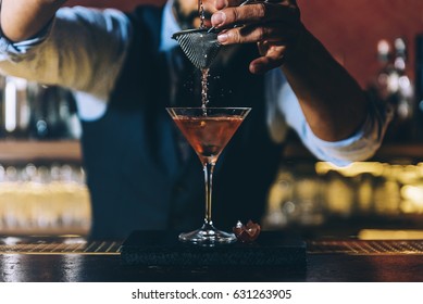 Expert Barman Is Making Cocktail At Night Club.