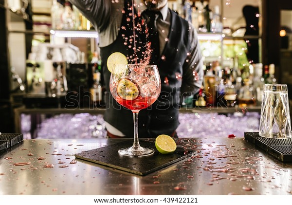 Expert barman is\
making cocktail at night\
club.