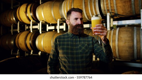 
expert brewer of beer tastes in style hipster uan clear double malt beer. concept of craft beer and plenty of hops. - Powered by Shutterstock