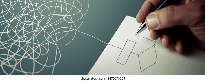 Expert business hand solving tangled line, outside the paper sheet on a blue desk - Shutterstock ID 1478673365
