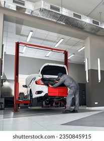 Expert Car Repair. Skilled Mechanic Conducts Maintenance in Service Panorama. Mechanic repairing a car.