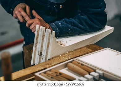 Expert Carpenter Working On A Wood Element With A Chisel. Detail Of Hands And Tools At Work In A Woodshop. Sustainable Design, Circular Economy, Honest Job. Ecology And Occupation Concept.