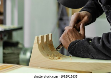 Expert Carpenter Working On A Wood Element With A Chisel. Detail Of Hands And Tools At Work In A Woodshop. Sustainable Design, Circular Economy, Honest Job. Ecology And Occupation Concept.