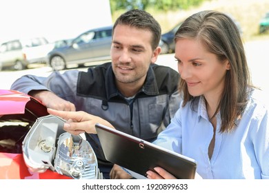 Expert Checks The Cost Of A Car Reparation