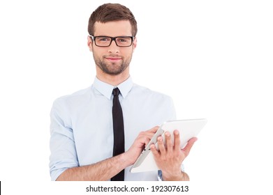 Expert In Digital Technologies. Cheerful Young Man In Formal Wear Working On Digital Tablet And Smiling While Standing Isolated On White Background