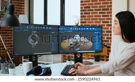 Expert engineer develops industrial prototypes using 3D modeling software at her home office, featuring dual monitors and modern office equipment perfect for innovative design processes. Camera A.