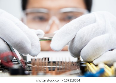 Expert engineers examining computer equipment.