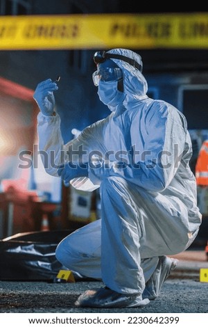 Expert Finding a Bullet Shell Believed to Match the Victim's Fatal Wound. Major Break in the Murder Case When Forensics Specialist Finds Evidence related to Murder Weapon Used by the Killer