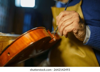 Expert luthier assembling delicate violin parts with precision and care in a traditional workshop, highlighting the artistry and craftsmanship of handmade instruments