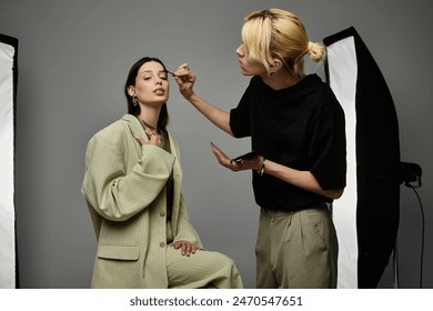 Expert makeup artist applying makeup to a womans face. - Powered by Shutterstock