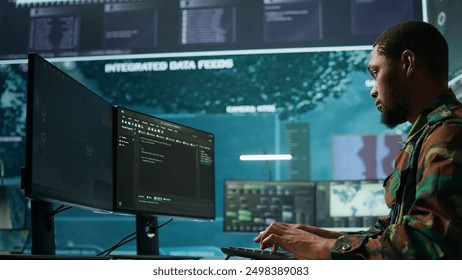 IT expert monitors AI brain intelligence system to collect crucial real time data for a new defense military operation on pc in command post. Security protocols for an intense mission. Camera B. - Powered by Shutterstock