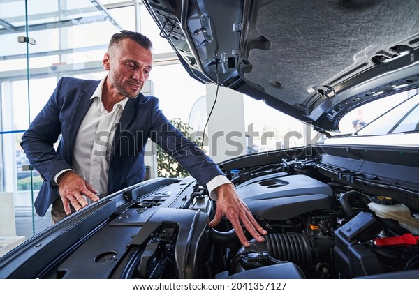Expert in selling cars paying attention to under\
hood parts