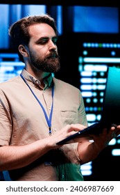 Expert in server room with advanced data storage infrastructure storing massive datasets, supporting intensive operations requiring IT equipment to run at high power densities