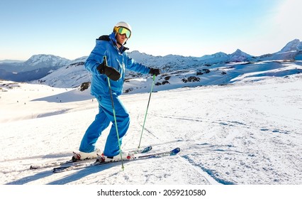 Expert Skier On Blue Uniform On Relax Moment At French Alps Ski Resort - Winter Adventure And Sport Concept With Professional Guy On Mountain Top Ready To Ride Down - 