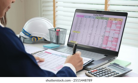 Expert woman asian female people review data number costing managerial account prepare monthly actual cost variance report at tax audit office. ESG sheet budget control ERP process service project. - Powered by Shutterstock