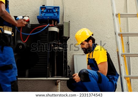 Experts fixing defective blower fan causing frozen evaporator coil, resulting in poor airflow. Knowledgeable professionals optimizing HVAC system, ensuring it operates at maximum performance